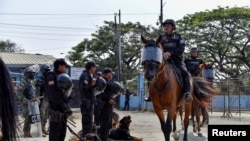 Mounted riot police leave the jail during ongoing prisoner transfers done as part of a government plan to reduce overcrowding in the country's prisons, in Guayaquil, Ecuador, on Nov. 1, 2022.