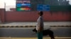 An Indian looks at the air quality level board outside India Meteorological Department, which shows condition of air as severe post during Diwali festival, in New Delhi, Oct. 20, 2017.