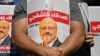 FILE - Friends of slain Saudi journalist Jamal Khashoggi hold posters bearing his picture as they attend an event marking the second anniversary of his assassination in front of Saudi Arabia's Istanbul Consulate, on Oct. 2, 2020. 