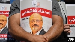 FILE - Friends of slain Saudi journalist Jamal Khashoggi hold posters bearing his picture as they attend an event marking the second anniversary of his assassination in front of Saudi Arabia's Istanbul Consulate, on Oct. 2, 2020. 