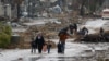 Palestinians fleeing north Gaza move southward as ambulances head towards north Gaza during a temporary truce between Israel and Hamas, near Gaza City, Nov. 27, 2023.