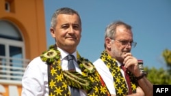 FILE - French Interior and Overseas Minister Gerald Darmanin (L) looks during a visit in Mamoudzou on the French Indian Ocean island of Mayotte, June 24, 2023. 