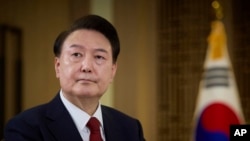 In this photo provided Feb. 7, 2024, by the South Korea Presidential Office, South Korean President Yoon Suk Yeol speaks during a pre-recorded interview with KBS television at the presidential office in Seoul, South Korea, Feb. 4, 2024.