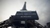 A sign accouncing the closing of the Eiffel Tower due to a strike is seen in front of the 19th century landmark in Paris, France, Feb. 19, 2024.