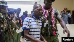 FILE - Paul Mackenzie, a Kenyan cult leader accused of ordering his followers, to starve themselves to death in Shakahola forest, is escorted to the Malindi Law Courts in Malindi, Kilifi, Jan. 17, 2024.