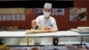 FILE - A sushi chef prepares a plate at the Toyosu Market, Jan. 29, 2024, in Tokyo.