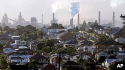 FILE - Smoke billows out of a chimney stack of steel works factories in Port Kembla, south of Sydney, Australia, July 2, 2014.
