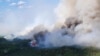 FILE — Smoke rises above the southeast perimeter of the Paskwa fire near Fox Lake, Alberta, Canada, May 16, 2023. Seventeen wildfires have broken out in Alberta in 2024; 52 have been burning since last year. (Alberta Wildfire/Handout via Reuters) 