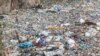 A volunteer searches through a rubbish dump for human remains at Mukuru slum in Nairobi, Kenya, July 14, 2024. 