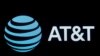 FILE - The AT&T company logo is displayed on a screen on the floor at the New York Stock Exchange (NYSE) in New York, Sept. 8, 2019. 