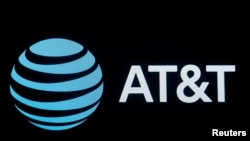 FILE - The AT&T company logo is displayed on a screen on the floor at the New York Stock Exchange (NYSE) in New York, Sept. 8, 2019. 
