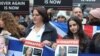 Women hold images of hostages held in Gaza, during a march against antisemitism, in London, Nov. 26, 2023. 