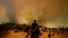 A resident flees an encroaching forest fire in Vina del Mar, Chile, Feb. 3, 2024. 