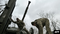 Ukrainian servicemen check their Sweden made CV90 armored infantry combat vehicle on a position pointing in the direction of Bakhmut in the Donetsk region on Nov. 27, 2023, amid the Russian invasion of Ukraine. 