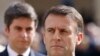 FILE - French President Emmanuel Macron and French Prime Minister Gabriel Attal, background, attend a ceremony in Paris, March 20, 2024. Following a snap legislative election, Macron has lost his parliamentary majority.