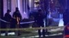 Law enforcement officers stand by police tape near a scene where three men of Palestinian descent were shot and injured, in Burlington, Vermont, Nov. 25, 2023, in this still frame from video provided by WCAX-TV. (WCAX-TV via AP)