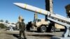 Iran's Defense Minister Brigadier General Mohammad-Reza Ashtiani walks near an Iranian missile during an unveiling ceremony in Tehran, Iran, in this picture obtained on Feb. 17, 2024. (Iran's Defense Ministry/WANA via Reuters)