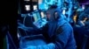 FILE - The U.S. Navy, Chief Fire Controlman (Aegis) Kenneth Krull, assigned to the USS Carney (DDG 64), mans the combat systems coordinator console in the combat information center during a general quarters drill on Oct. 14, 2023, in the Eastern Mediterranean.