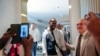 FILE - Sylvain Itte, French Ambassador to Niger, greets French journalist Olivier Dubois, center, at the airport in Niamey, Niger, March 20, 2023. Itte left Niger on Wednesday, about a month after the military government ordered his expulsion.