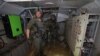 This photo, taken during a Feb. 8, 2024, media tour organized by the Israeli military, shows Israeli soldiers inside a tunnel that the army claims is a "Hamas command tunnel" under a compound of the UNRWA in Gaza City.