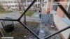 People clear broken glass after Russian drones hit a hospital in Stepanivka in the Kherson region, Ukraine, in this screengrab taken from a video released on Dec. 16, 2023. (Kherson Regional State Administration/Handout via Reuters)