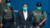 FILE - Jimmy Lai is escorted by Correctional Services officers to get on a prison van before appearing in a court in Hong Kong, Dec. 12, 2020.