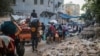 FILE - Palestinians carrrying their personal belongings flee the al-Bureij refugee camp in the central Gaza Strip on July 28, 2024. 
