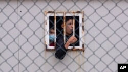 FILE - Children who crossed into Spain are seen inside a temporary shelter for unaccompanied minors in the enclave of Ceuta, next to the border of Morocco and Spain, May 20, 2021.