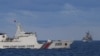 A Chinese Coast Guard ship sails near a Philippine vessel, right, that was part of a convoy of civilian boats in the disputed South China Sea on Dec. 10, 2023.