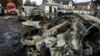 A man walks next to cars destroyed in a Russian missile and drone attack, in Kyiv, Ukraine, Dec. 29, 2023.