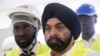 FILE - New World Bank President Ajay Banga stands with officials during his visit at the headquarters of Ivorian electricity company of Yopougon in Abidjan, Ivory Coast, March 7, 2023.