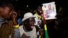 Supporters of Senegalese presidential candidate Bassirou Diomaye Faye celebrate early results showing that Faye is leading initial presidential election tallies, in Dakar, Senegal, March 24, 2024. 