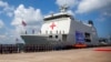 FILE - Military personnel stand near Indonesian Navy hospital ship KRI dr. Radioman Wedyodiningrat during the opening ceremony of the military non-combat exercise called ASEAN Solidarity Exercise at Batu Ampar Port on Batam island, Sept. 19, 2023.