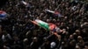 Palestinians carry the ones that where killed after an Israeli military raid on Nur Shams refugee camp in the West Bank, Dec. 27, 2023.