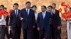Vietnam's Prime Minister Pham Minh Chinh, center right, talks with China's President Xi Jinping, center left, after their meeting at the Government Office in Hanoi, Dec. 13, 2023.