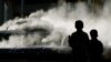 FILE - Two children look at a sculpture called 'Shell' but nicknamed by locals
as 'Steaming Dog Poo' in Sydney.