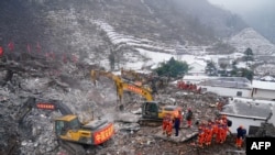 Rescue workers search for missing victims at a landslide site, a day after a landslide hits Liangshui village in Zhaotong, in southwestern China's Yunnan province on Jan. 23, 2024. (Photo by CNS / AFP)