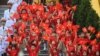 FILE - Children wave Vietnamese national flags during a welcome ceremony for China's President Xi Jinping at the Presidential Palace in Hanoi, Dec. 12, 2023.