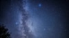 FILE - Shooting stars streak across the Milky Way during the 'Nuits des étoiles' (Starry Night), a major annual celebration for astronomy enthusiasts, in Fontainebleau, southern Paris, France, Aug. 13, 2023.