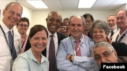 Colleagues gather with Elez Biberaj on Aug. 26, 2019.