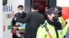 South Korean opposition party leader Lee Jae-myung, who was attacked in Busan, lies on a stretcher as he arrives at Seoul National University Hospital in Seoul on Jan. 2, 2024. 