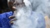 FILE - A man smokes cannabis popularly known as marijuana in Lagos, Nov. 11, 2019. The country's National Drug Law Enforcement Agency said over 14 million Nigerians use illegal drugs. The majority use locally-grown cannabis.