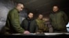 In this photo provided by the Ukrainian Presidential Press Office, President Volodymyr Zelenskyy, 2nd left, looks at a map during a visit to Avdiivka, the site of fierce battles with Russian troops, in Ukraine's Donetsk region, Dec. 29, 2023.