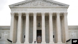 FILE - A police officer guards the main entrance to the Supreme Court in Washington, Oct. 9, 2018.