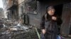 Svitlana Magdenko, 79, stands in front of her damaged house after a Russian rocket attack at a residential neighborhood in Kyiv, Ukraine, Dec. 13, 2023. 