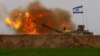 An Israeli mobile artillery unit fires a shell from southern Israel towards the Gaza Strip, in a position near the Israel-Gaza border, Dec. 21, 2023. 