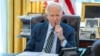 U.S. President Joe Biden speaks on the phone with Israeli Prime Minister Benjamin Netanyahu in this White House handout image taken in the Oval Office in Washington, April 4, 2024. 