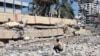 A man looks at the debris after an Israeli strike on a school, housing displaced Palestinians, in the Rimal neighborhood of central Gaza City on Aug. 20, 2024.