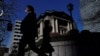 Pedestrians walk past the Bank of Japan building in Tokyo, Japan March 18, 2024. 