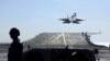 中國海軍遼寧號航母在進行一次遠海軍訓時一架艦載殲15戰機從航母上起飛。（2021年12月31日）
